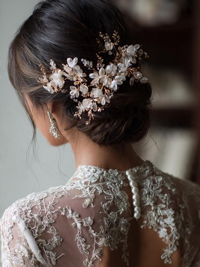 Elegant dark braided updo with a floral hairpiece by Ani Braids in Lanham, Maryland