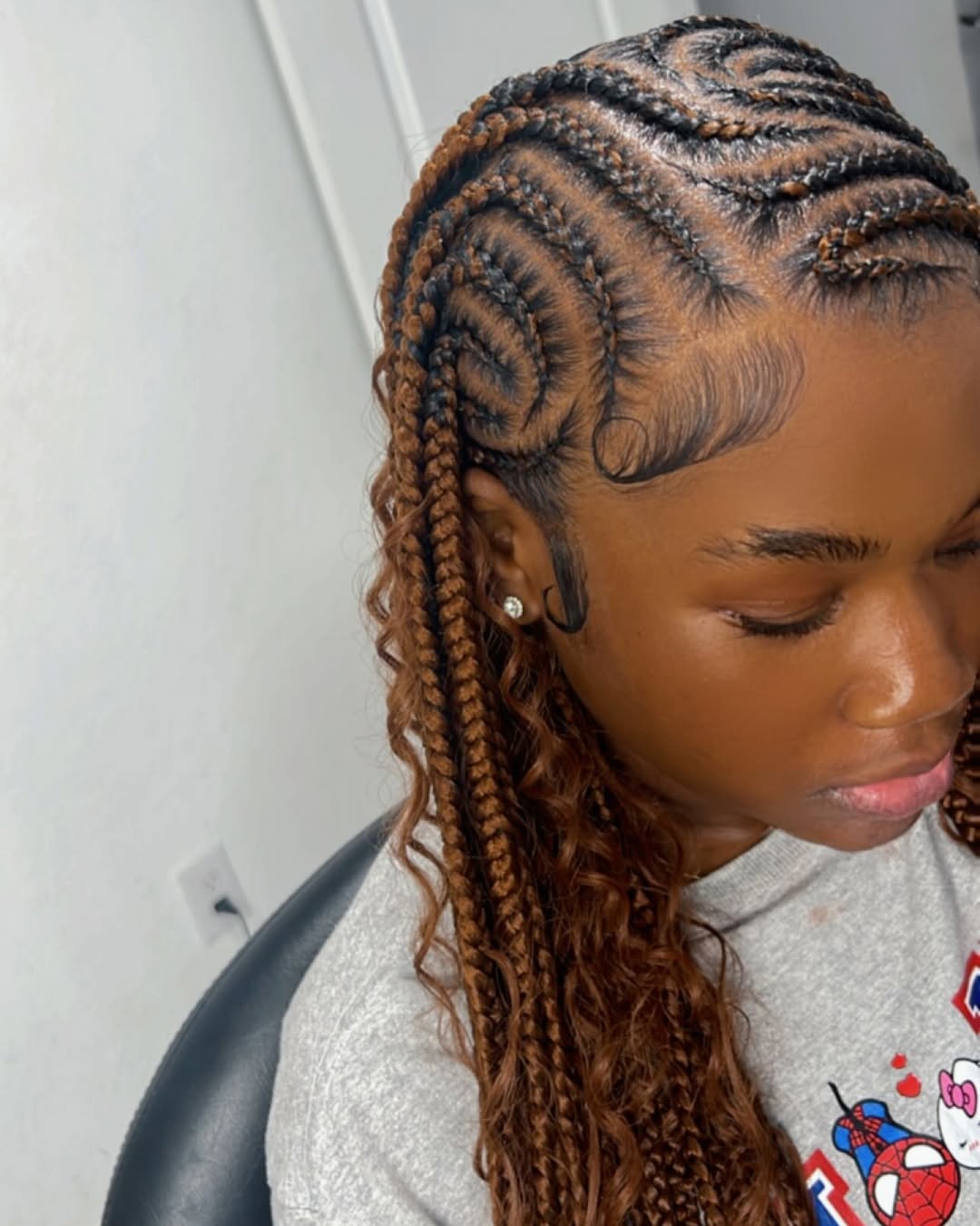 Curly boho cornrows with brown highlights by Ani Braids in Lanham, Maryland