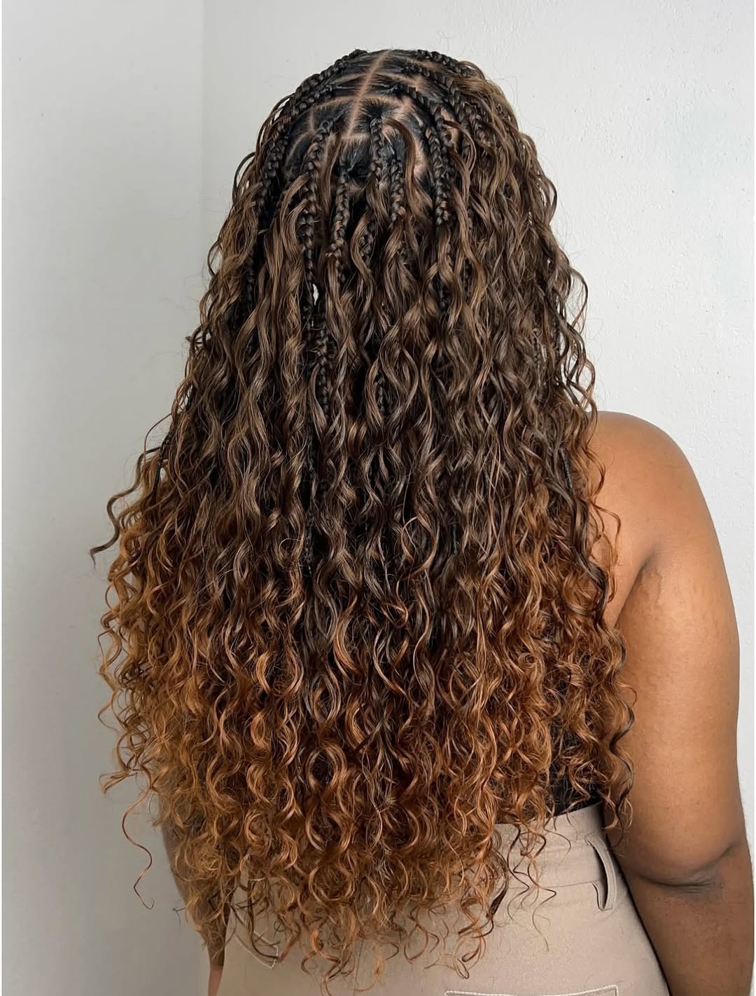 Boho box braids with dark roots and long curly brown-blonde ombre lengths by Ani Braids in Lanham, Maryland