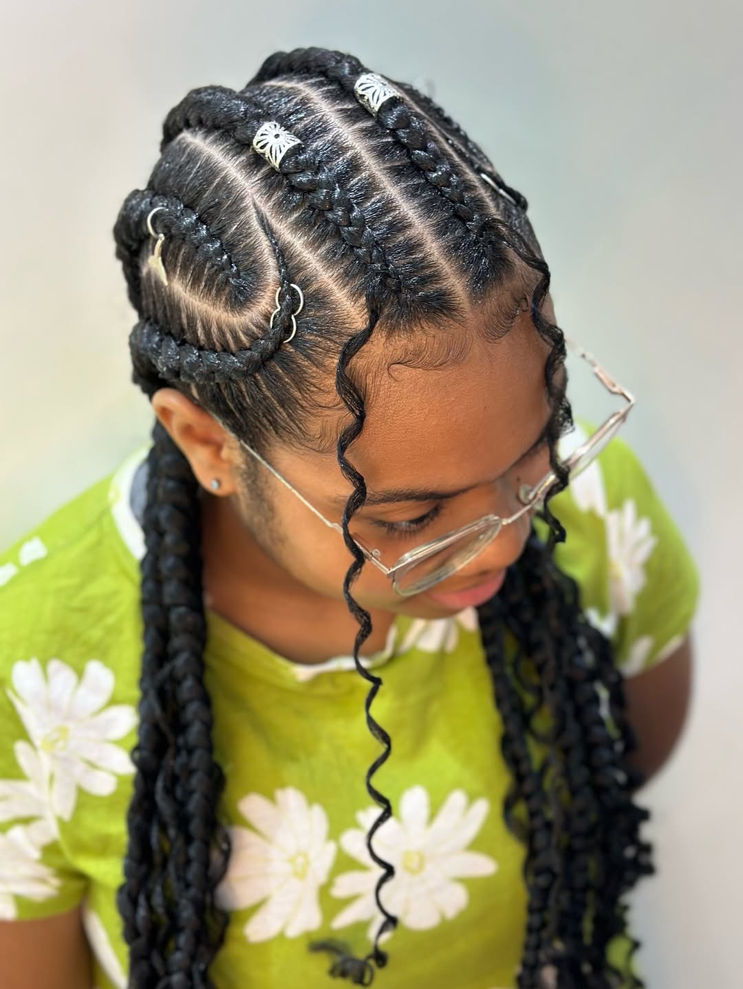 Cornrowed twists with silver hair rings in long black hair by Ani Braids in Lanham, Maryland