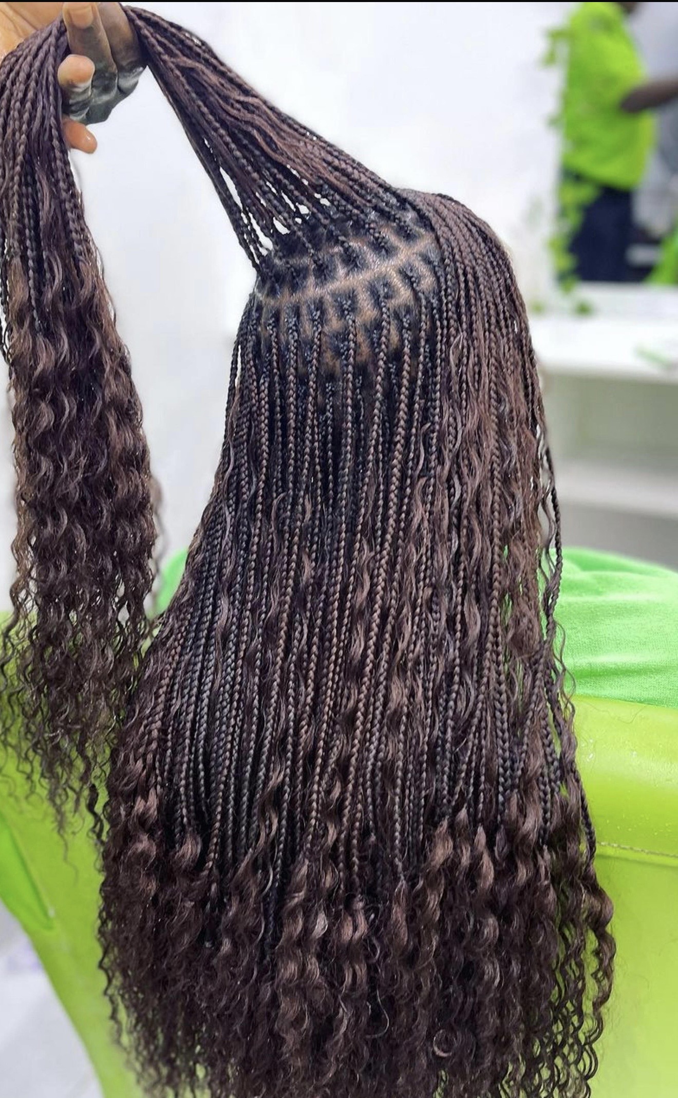 Shoulder-length dark brown bohemian box braids with wavy ends by Ani Braids in Lanham, Maryland