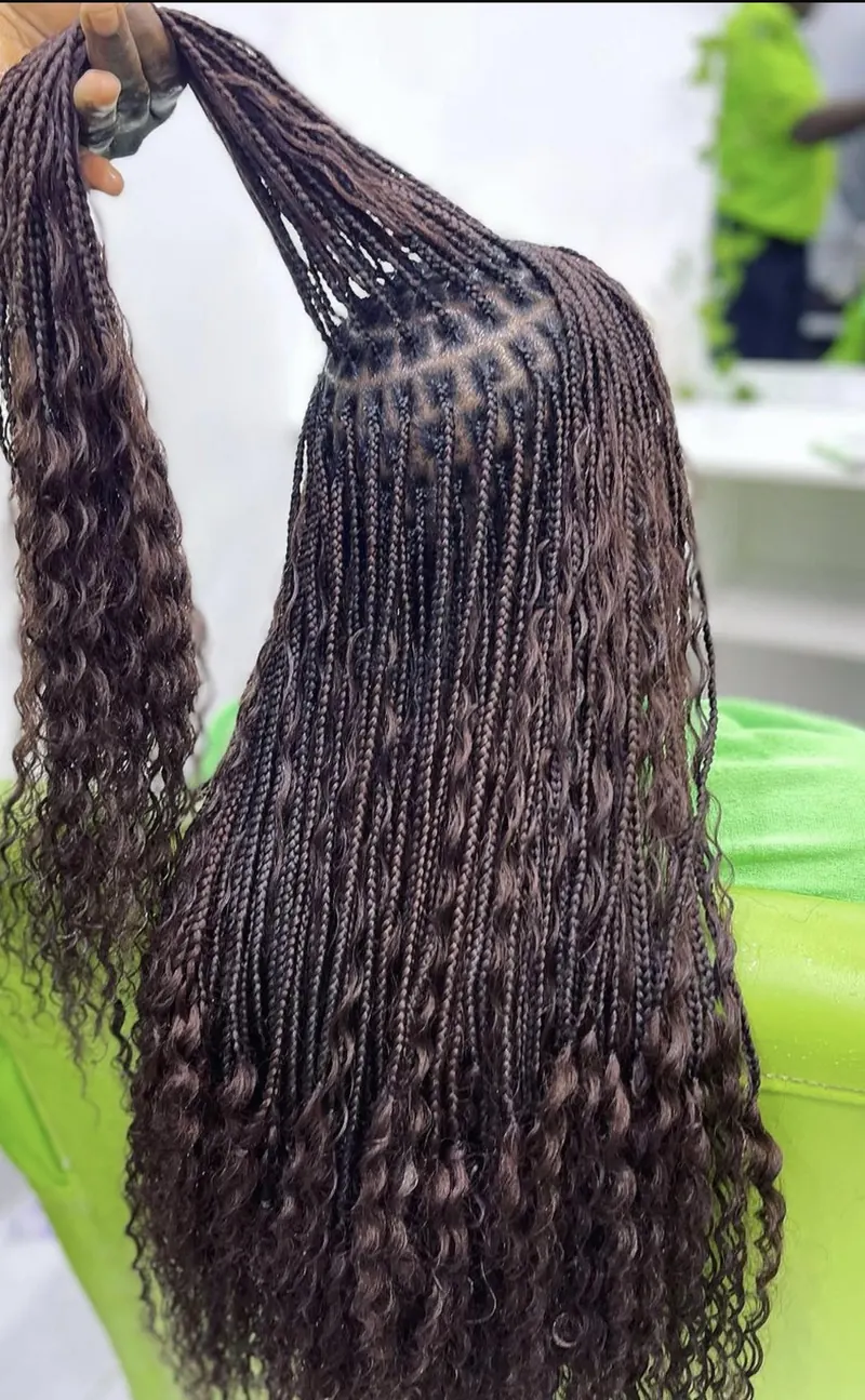 Shoulder-length dark brown bohemian box braids with wavy ends by Ani Braids in Lanham, Maryland